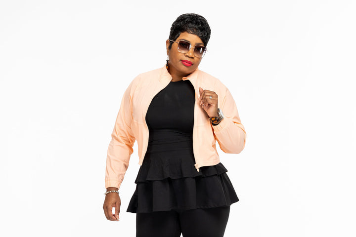 Stylish woman wearing a Pooh Wear Work to Workout athletic outfit with Pooh Wear Work jacket.