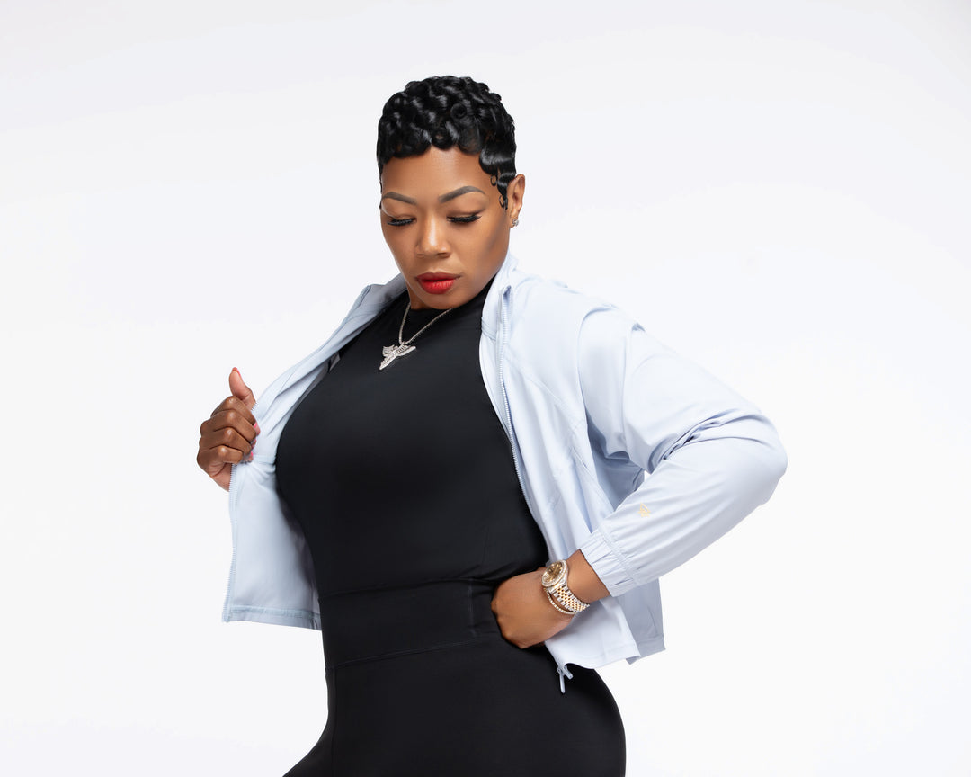 Stylish woman wearing a Pooh Wear Work to Workout athletic outfit with Pooh Wear Work jacket.