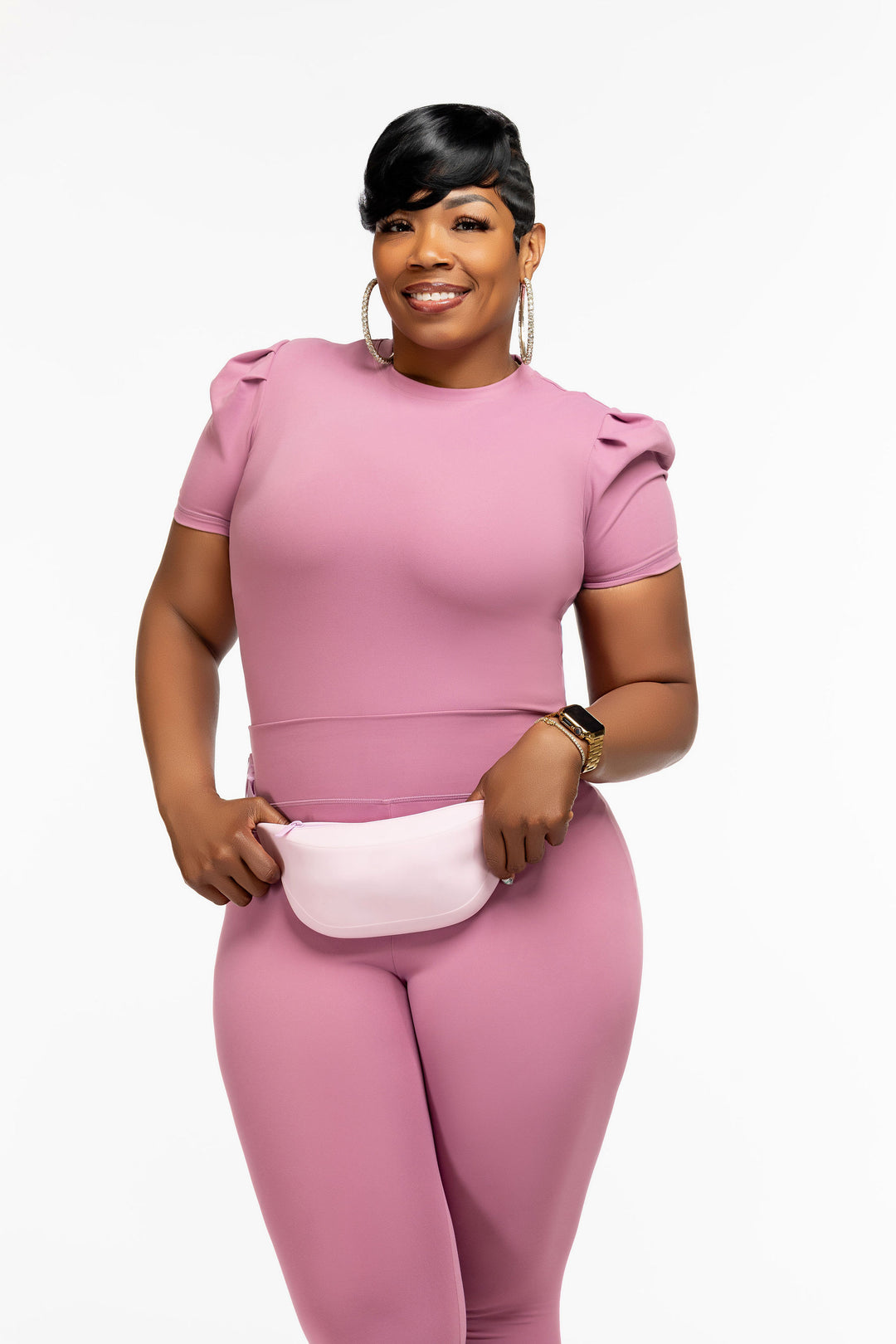 Stylish woman wearing a pink Pooh Wear athletic outfit with a Pooh Wear Work pouch (fanny pack)