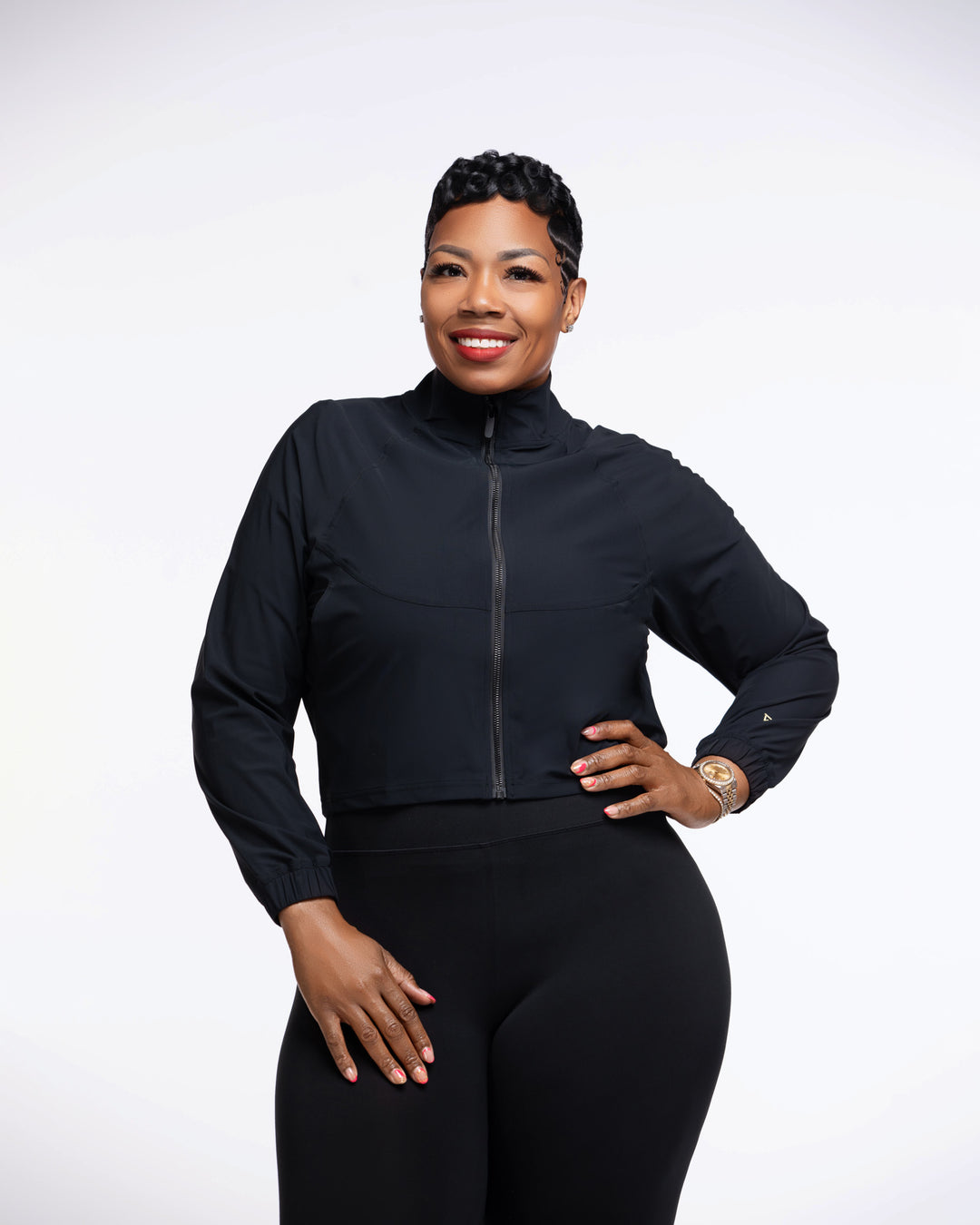 Woman wearing a black athletic outfit on a white background