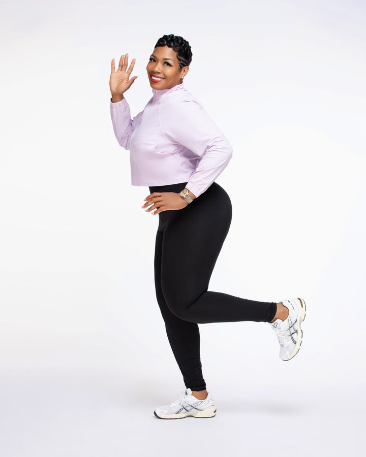 Stylish woman wearing a Pooh Wear Work to Workout athletic outfit with Pooh Wear Work jacket.